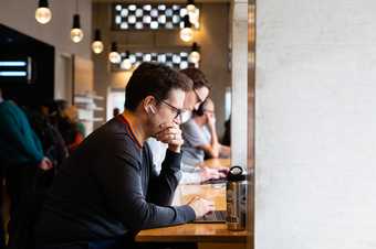 a person works on their laptop in a members space