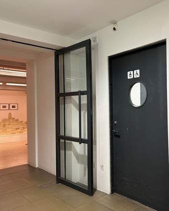 A photograph of the toilet sign on the second floor of Tate Liverpool