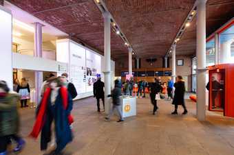 Tate Liverpool foyer with lots of visitors inside.